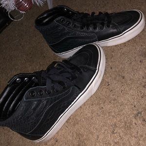 Vans high top shoes.